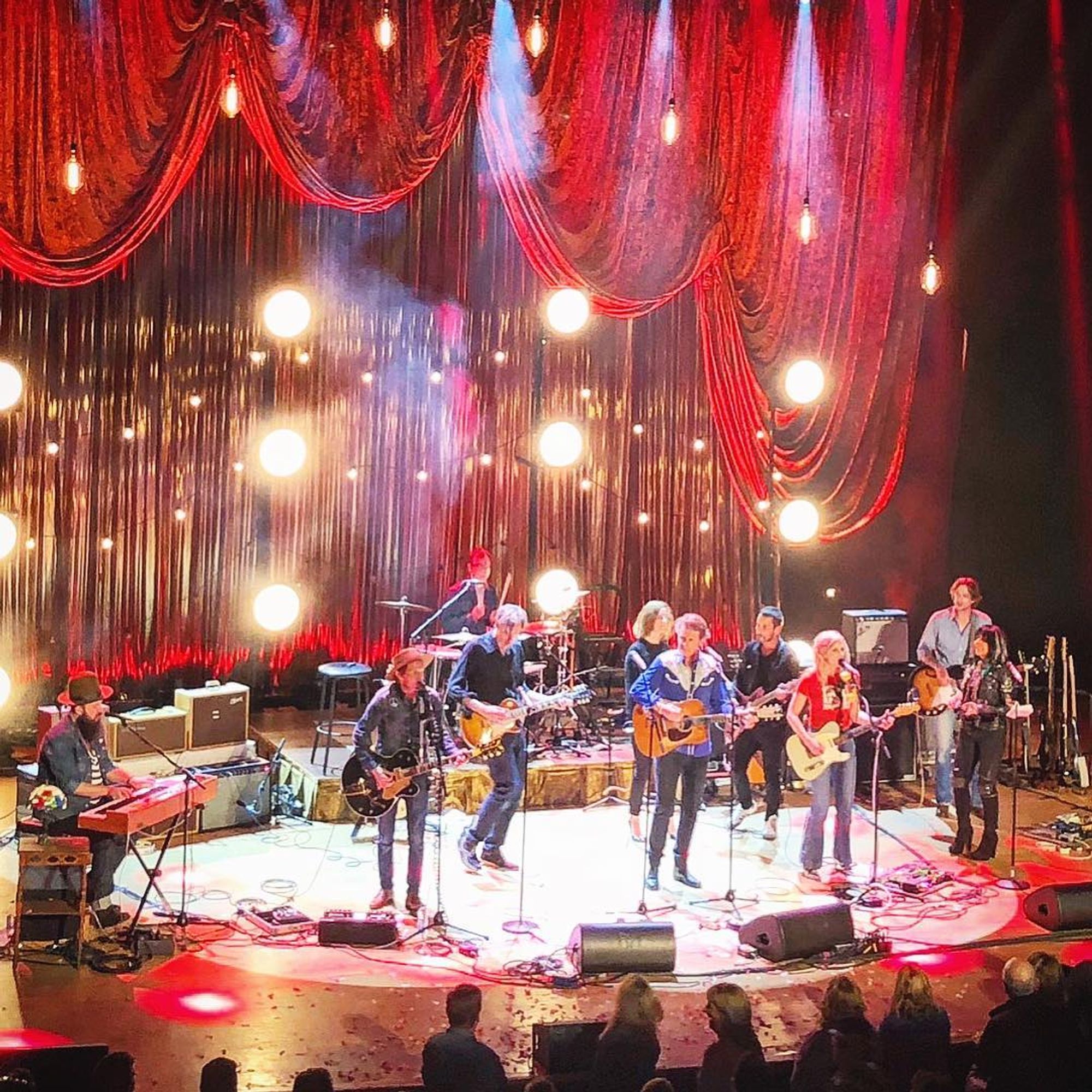 Concert crowd with hands raised during energetic live music performance