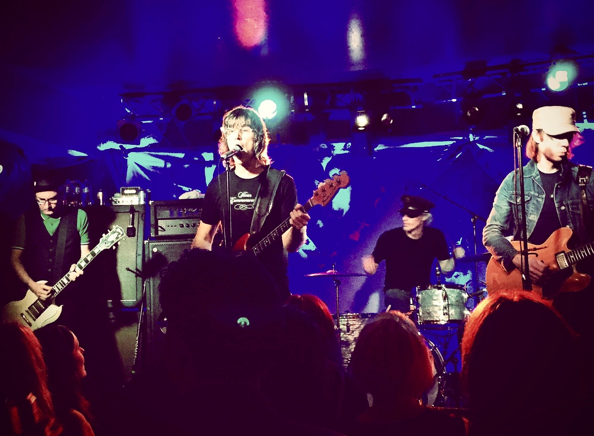 Solo artist performing acoustic guitar in intimate venue setting