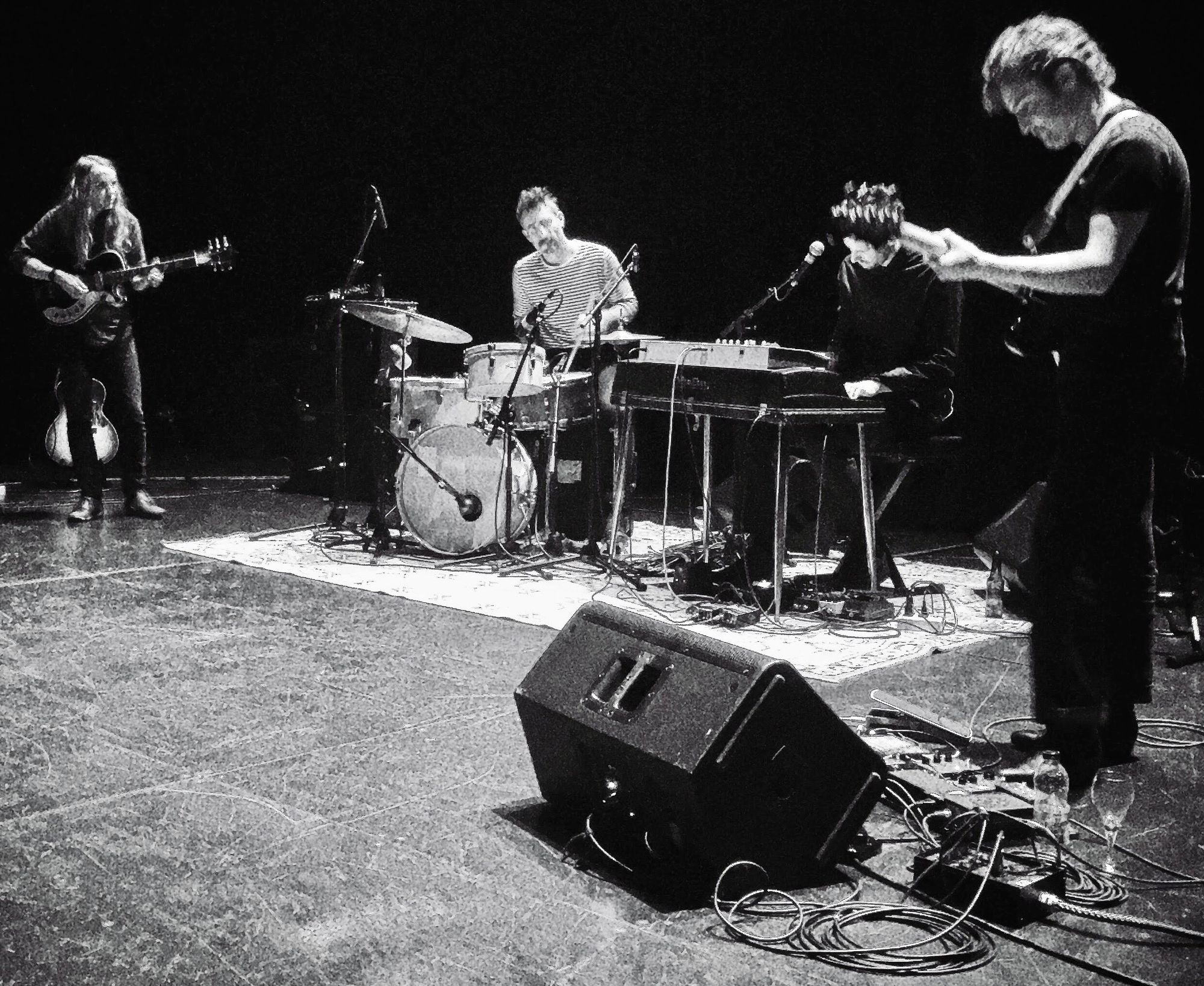 Band performing on stage with colorful concert lighting effects